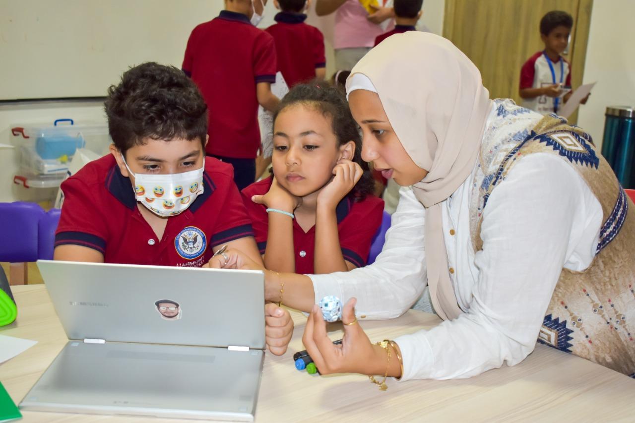 Children and adult woman engaged in interactive learning at IVY STEM International School