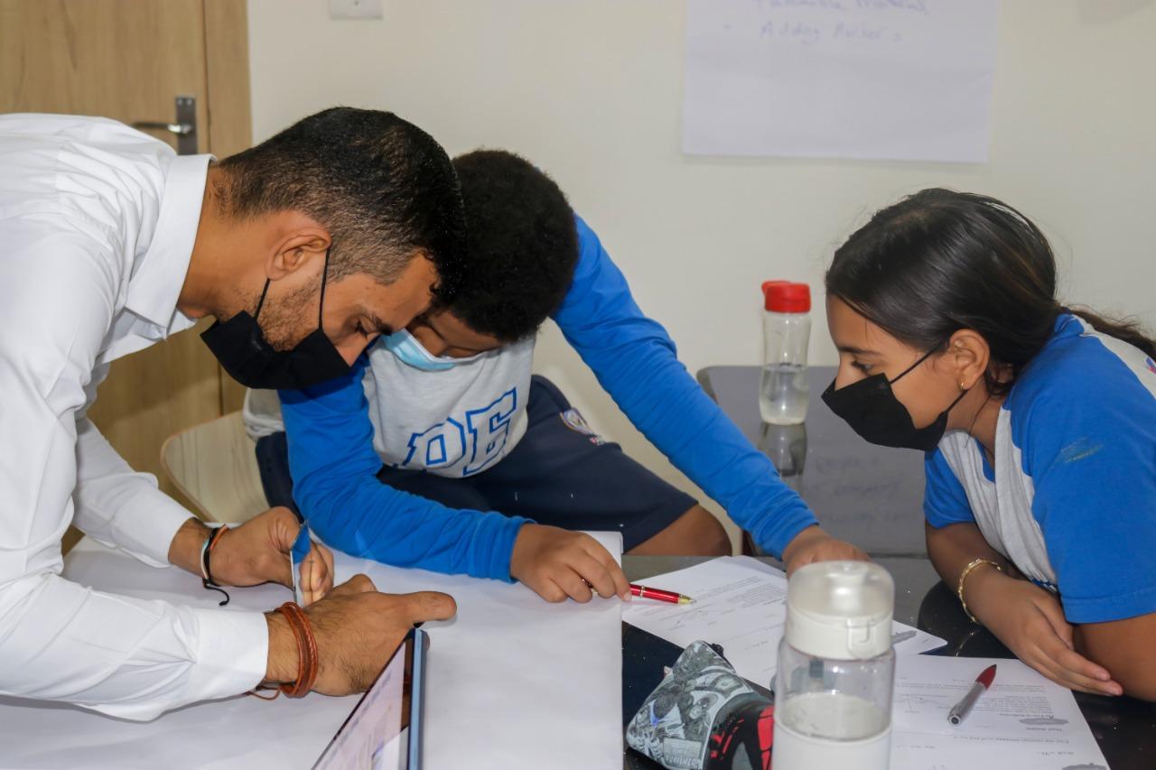 Group study at IVY STEM International School during the COVID-19 pandemic. Students collaborating on academic work in a classroom setting.